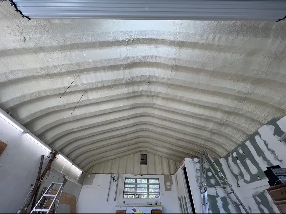 Spray polyurethane foam applied to the underside of a metal roof deck in Alton